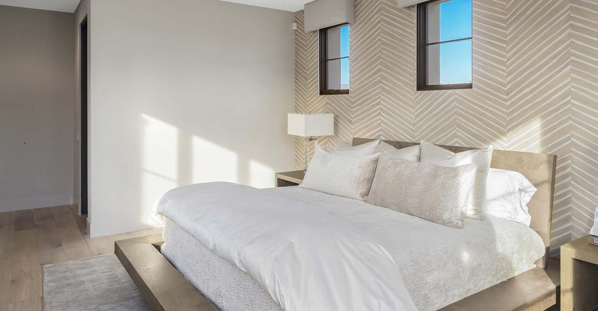 White crisp bedroom with unique wall design